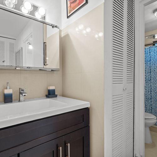 Sparkling Clean Bathroom: Refresh and rejuvenate in our pristine bathroom, featuring modern fixtures and ample space for your comfort.