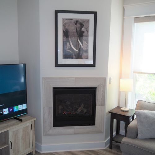 Living room:  gorgeous living room that features a gas fireplace and a large television with live streaming via hulu, netflix, and disney+.