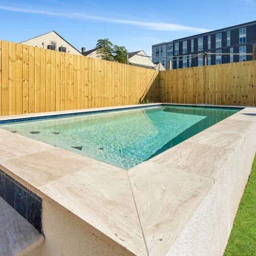 Crystal-clear pool gleaming in the sun, fully fenced for total privacy.
