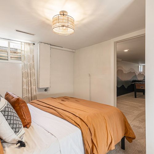Relax in a cozy queen bedroom located right next to the fun.