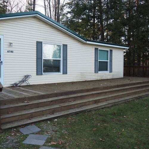 A closer view of the front of the house, highlighting the large front porch.