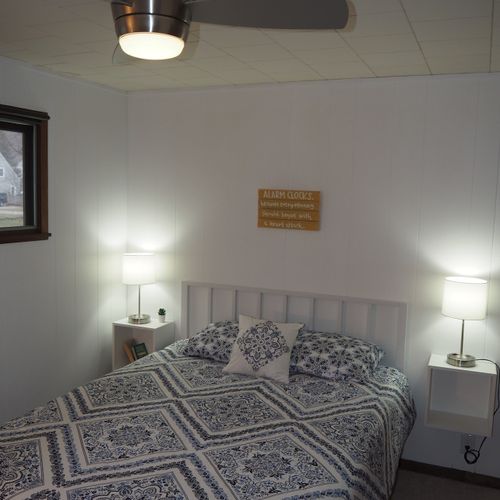 Bedroom #1:  features a queen-size bed, nightstands with lamps, ceiling fan, chair, dresser, closet, and full-length mirror.