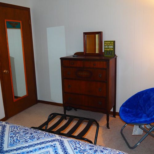 Bedroom #1:  features a queen-size bed, nightstands with lamps, ceiling fan, chair, dresser, closet, and full-length mirror.