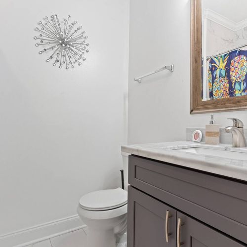 Clean, bright first full bathroom ready for your stay.