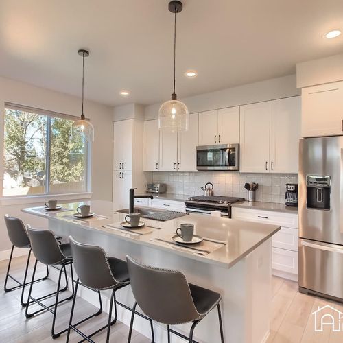 - spacious kitchen includes quartz countertops, full appliances, and seating for four
- pendant lights and large window brighten the space with a cozy breakfast feel
- ideal for morning coffee, casual meals, or chatting with the chef