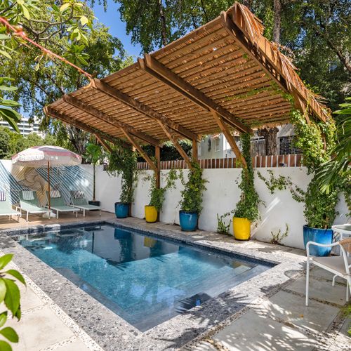 huge  refreshing pool with sunbathing beds and chairs, terrace with gazebo