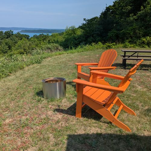 EXTERIOR:  The outdoor firepit, chairs, and picnic table with Crystal Lake in the background