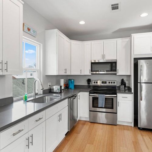Fully stocked kitchen w/ stainless steel appliances & ample cabinet space.