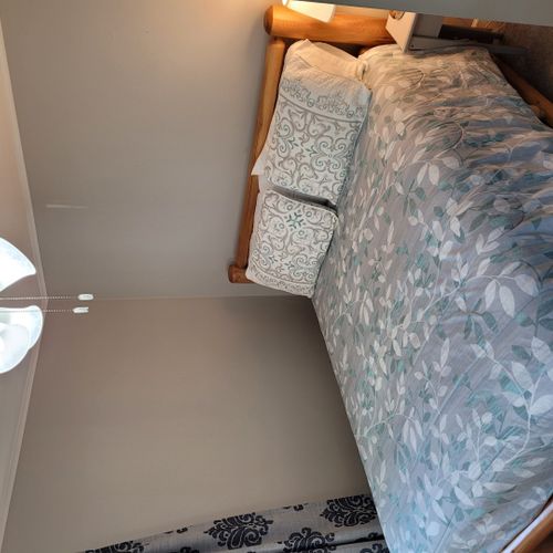 Bedroom #1:  features a queen-size bed, ceiling fan, nightstand, lamp, closet, and dresser.