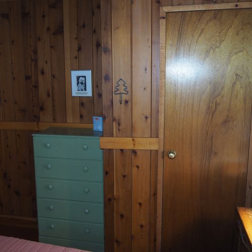 Bedroom #1 (main floor):  features a queen-size bed, nightstands with lamps, a dresser and a closet.
