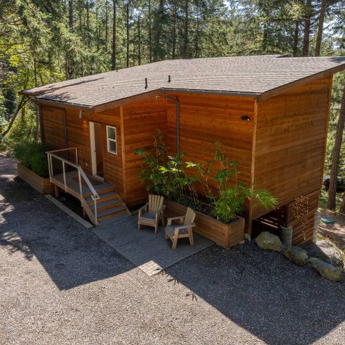 Custom cedar siding and a unique hillside design make Tree Haven a spacious home that seamlessly blends into its environment.