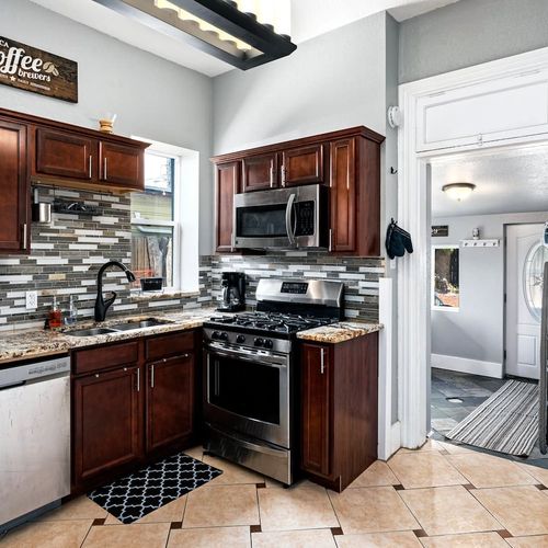 - cook like a pro with a gas range, built in microwave, and ample prep space
- open layout connects to laundry area for ultimate guest convenience
- stylish tile floors and modern lighting add to the inviting atmosphere