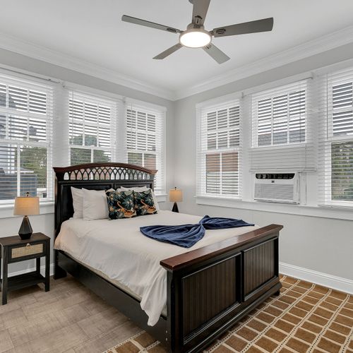 Sleep in luxury! This beautifully appointed bedroom features a plush bed, elegant decor, and ample natural light for a relaxing and restful stay.