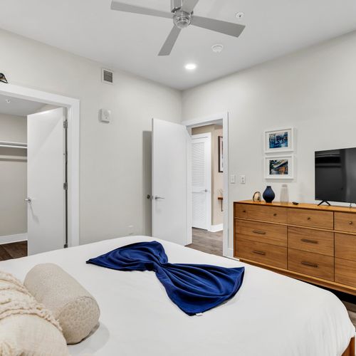 Modern comfort meets artistic flair in this inviting bedroom space.