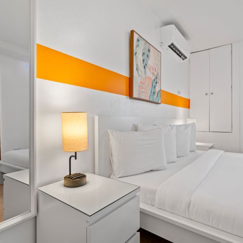 Experience the ultimate relaxation in our inviting bedroom, designed for deep sleep with a plush bed, warm bedside lamp, and convenient nightstand for your evening reads.