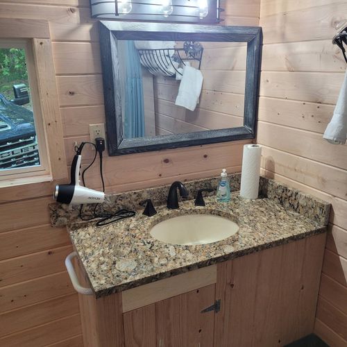 Bathroom:  very cute full bathroom with sink, vanity, mirror, shower, and toilet