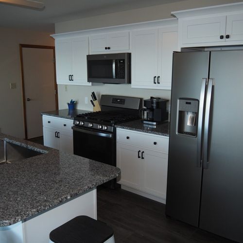 Kitchen:  newly remodeled and features a gas stove and stovetop, refrigerator, microwave oven, dishwasher, keurig coffee maker, toaster, island with sink, barstools, lots of counter space and cabinets, and a good supply of cooking & dining utensils.