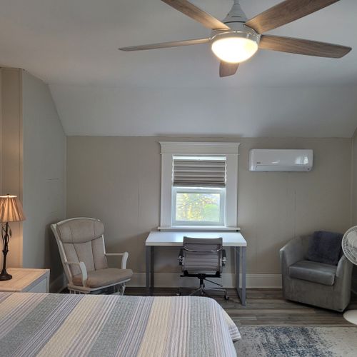 Bedroom #2 (second floor):  huge upstairs bedroom with a king-size bed, nightstands, lamps, 2 dressers, private television with live streaming, mini-split a/c unit, ceiling fan, desk with chair, comfy chairs, and a closet.