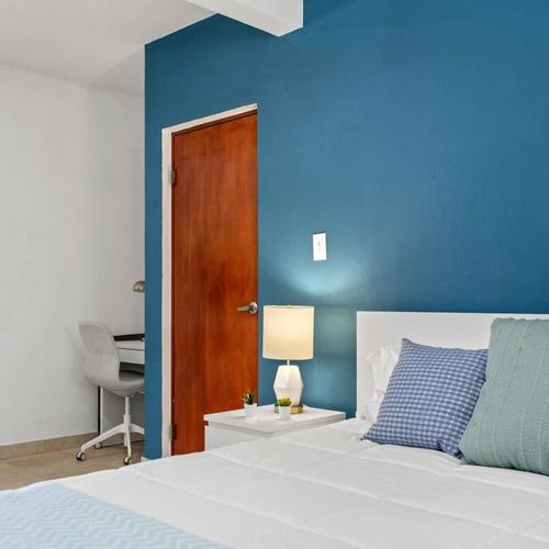 The comfortable bedding invites you to unwind, and the adjacent window allows fresh air to flow in.