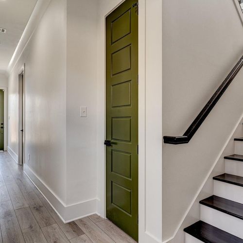 Hallway behind the kitchen leading to the stairs & additional spaces.