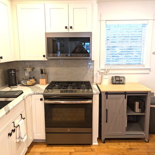 KITCHEN (MAIN FLOOR):  Fully-functional modern kitchen with newer appliances including a dishwasher and a gas range.