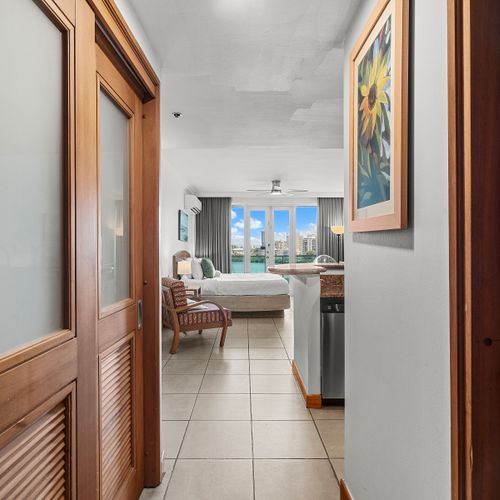Welcome to your stylish retreat! Enjoy seamless flow from entry to the sun-drenched living space with stunning lagoon views