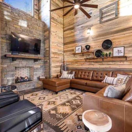 The living room features couches and chairs nestled around a fireplace!