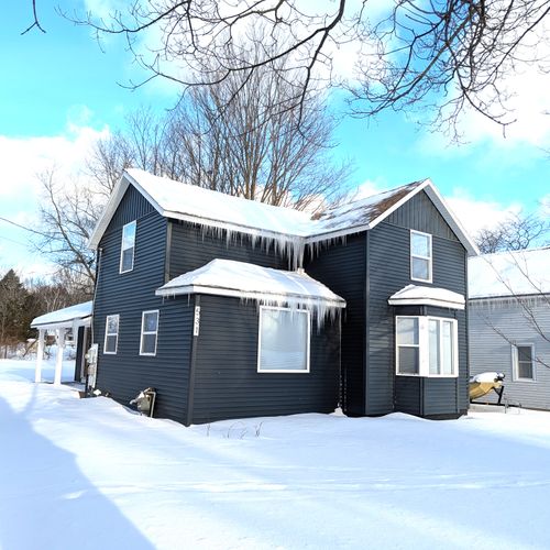EXTERIOR:  The front of the house in winter