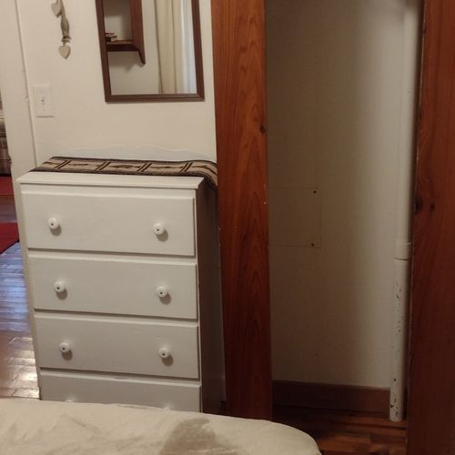 Bedroom #1:  features a full-size bed, nightstand, lamp, dresser. And closet.