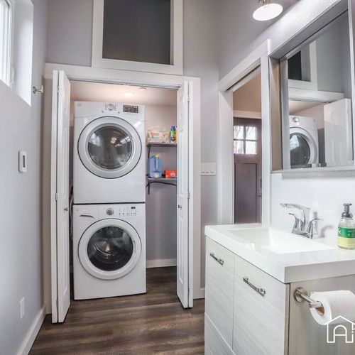 The washer and dryer are located in the bathroom.