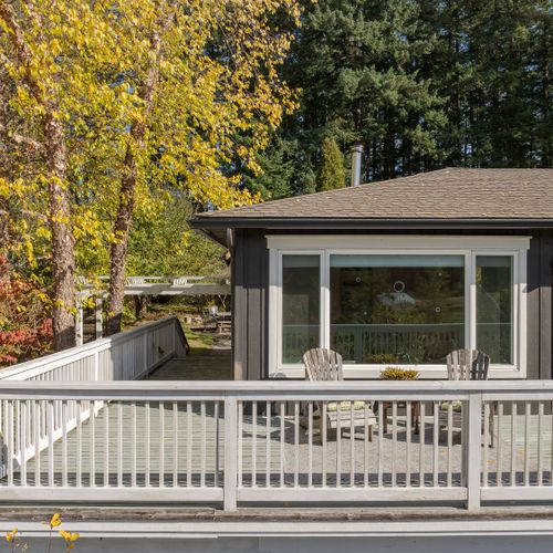 Spacious wraparound deck with Adirondack seating.