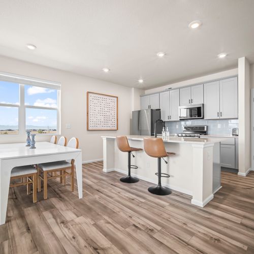 Clean, contemporary kitchen with comfortable dining space and plenty of natural light.