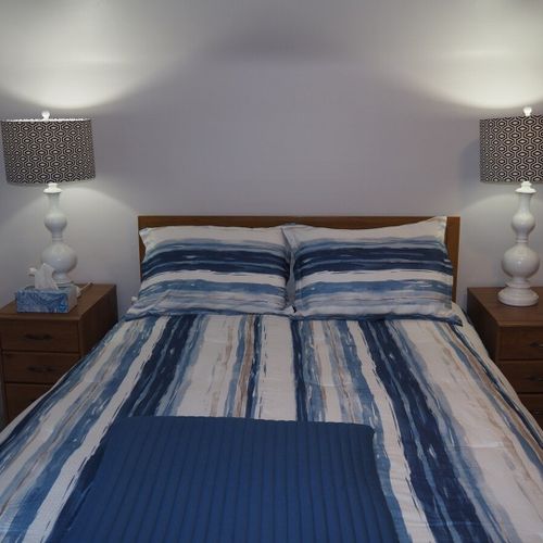 Bedroom #1:  all 3 bedrooms are upstairs. This bedroom features a queen-size bed, nightstands with lamps, dresser, chair, and a large closet.