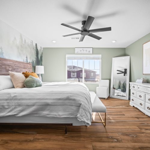 Spacious primary bedroom with natural light, full size mirror and convenient dresser.