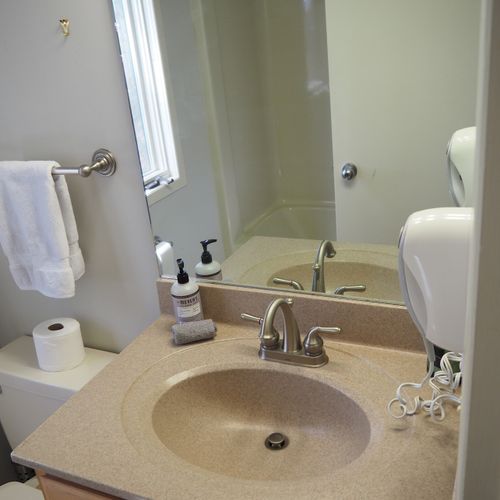 Guest bathroom:  this is a full bathroom that has a common entrance. It includes a combination tub and shower.