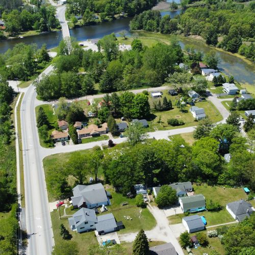 Exterior:  looking west with the house in the foreground and the au sable river in the background.