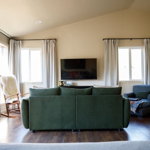 A cozy seating area in the master suite offers the perfect spot to unwind and enjoy the views after a day of adventure.