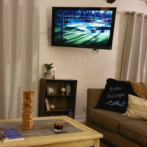 Living room:  the cottage features a very bright, modern, and fun living room with a beachy design and a wall-mounted television with live streaming via roku.