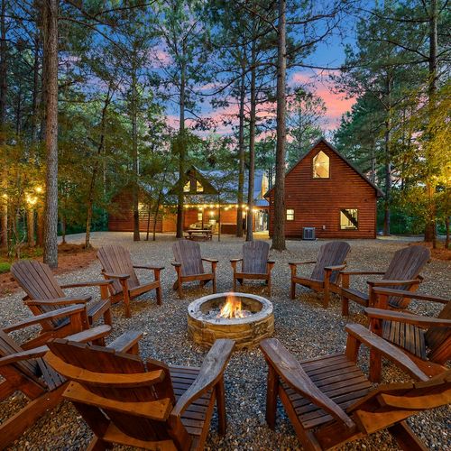 The fire pit is surrounded by chairs.