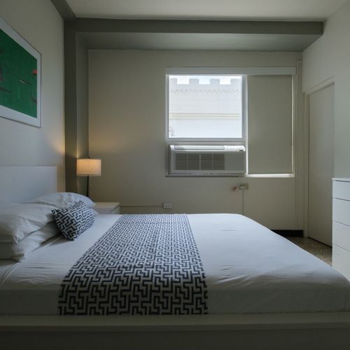 Fresh and functional! This modern bedroom boasts a comfortable queen bed with stylish bedding, providing a chic yet relaxing space for your stay.