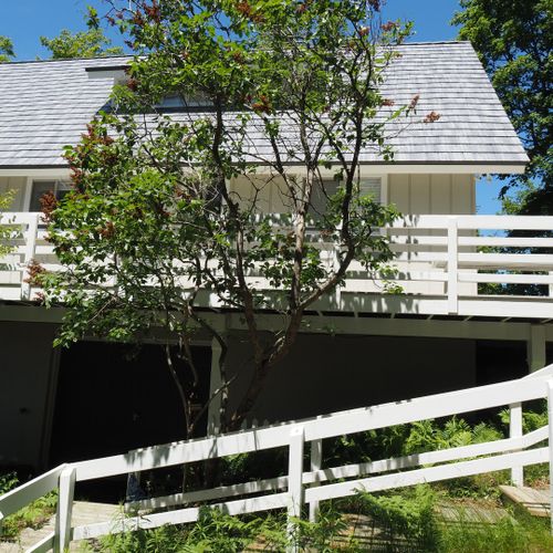 Exterior:  the southern side of the house with the garage door in the middle.