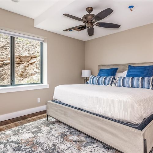 - rest easy in this peaceful king bedroom with a plush bed and calming neutral palette
- ceiling fan overhead and soft area rug underfoot add comfort to your stay
- ideal for couples or solo travelers looking for restful mountain nights