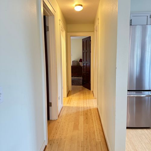 A quiet, well-lit hallway that keeps bedrooms and bathrooms tucked away for privacy while making it easy to move between spaces without disturbing others.