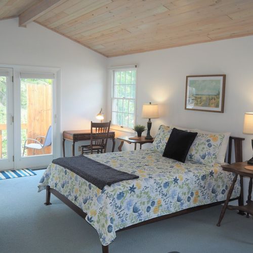 Bedroom #1 (main floor):  huge master bedroom featuring a king-size bed, desk, private television, private en suite full bathroom, chairs, dresser, walk-in closet, and even a private laundry room!