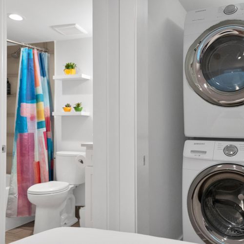 Convenient in-unit laundry w/ washer & dryer tucked neatly behind a stylish door.
