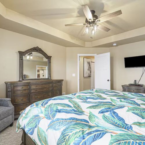 With a tv and plush sofa in the master bedroom, you can indulge in comfort and entertainment at any time.