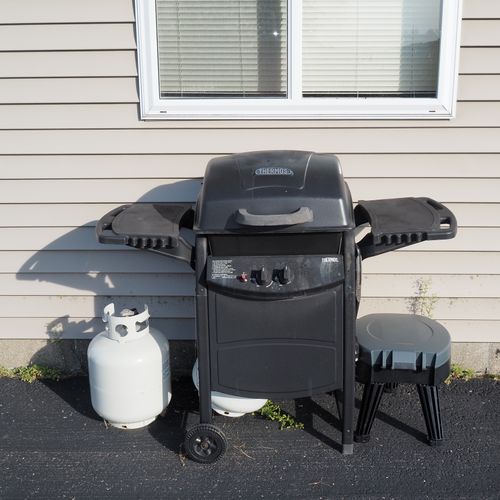 Exterior:  the propane grill that is next to the garage.