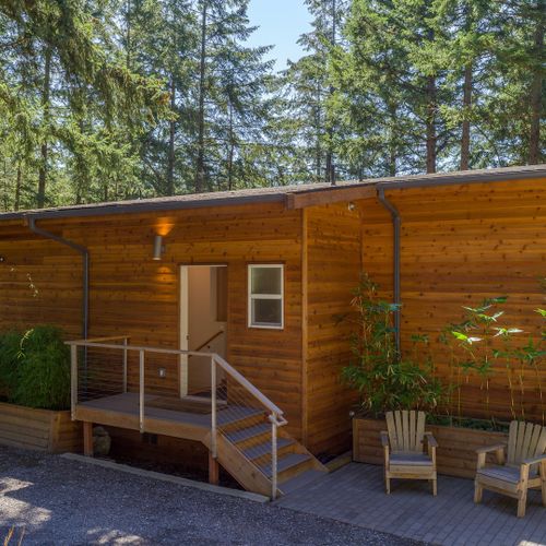 Clean modern lines meet natural cedar warmth — Tree Haven's exterior blends seamlessly into its old-growth surroundings.