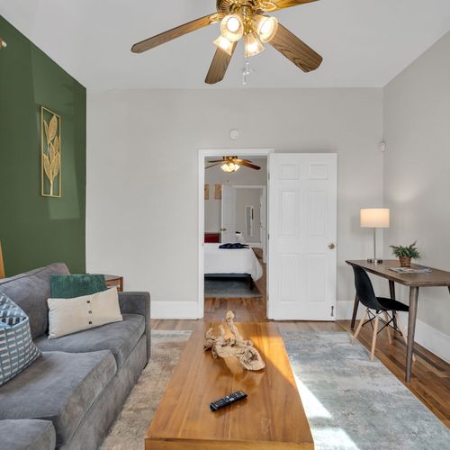 Light-filled living space w/ stylish green accents & modern finishes throughout.