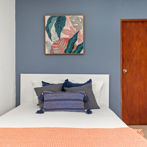 Sleep in style! This beautiful bedroom features a calming color palette and a cozy bed, designed for ultimate rest and rejuvenation.